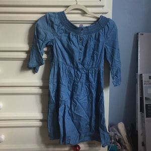 Blue dress with button and open cuff wrists. Elbow length sleeves.